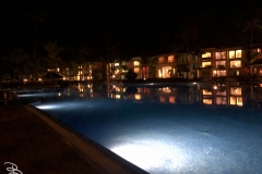 Pool and resort building at night.